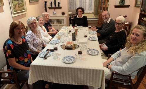 A group of people around a table

Description automatically generated
