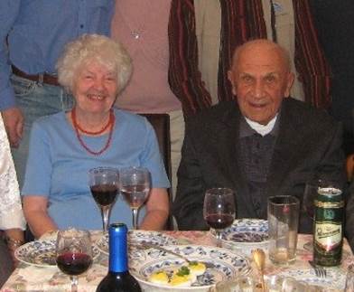 A group of people sitting at a table with wine glasses

Description automatically generated
