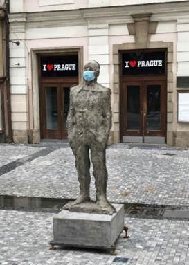 A statue in front of a brick building

Description automatically generated