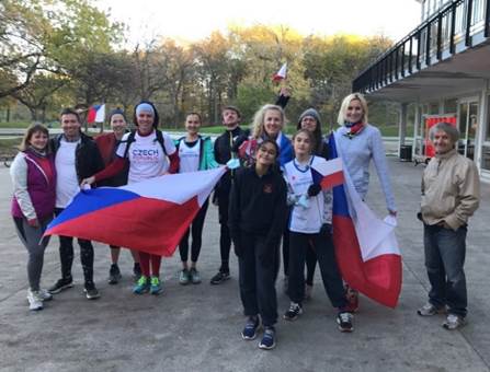 A group of people holding a flag

Description automatically generated