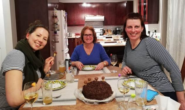 A group of women sitting at a table with food

Description automatically generated with medium confidence