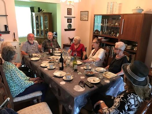 A group of people sitting around a table

Description automatically generated with medium confidence