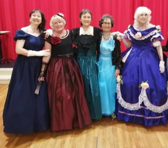 A group of women in dresses

Description automatically generated