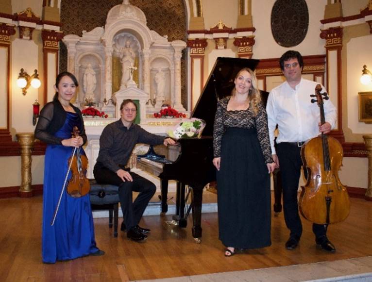 A group of people posing for a photo

Description automatically generated