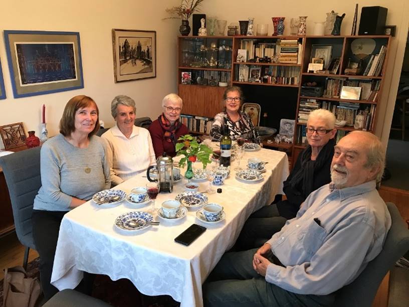 A group of people sitting around a table

Description automatically generated
