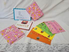 A group of colorful envelopes on a white surface

Description automatically generated