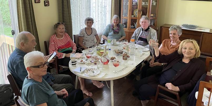 A group of people sitting around a table
Description automatically generated