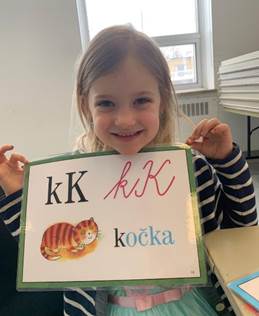 A child holding a sign

Description automatically generated