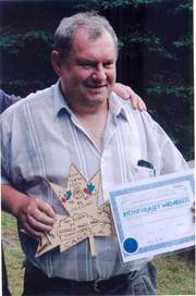 A person holding a certificate and a star

AI-generated content may be incorrect.