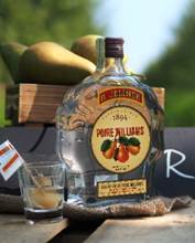 A bottle of liquor next to a shot glass

AI-generated content may be incorrect.