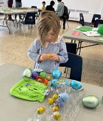 A child sitting at a table with colorful eggs

AI-generated content may be incorrect.