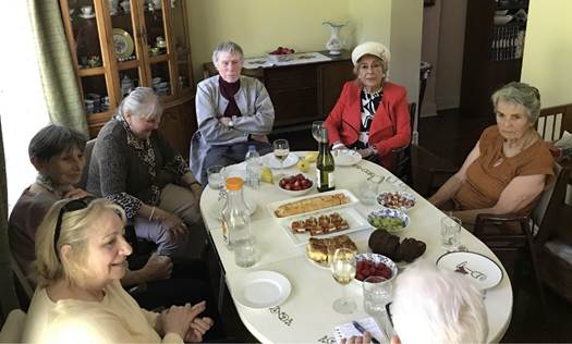 A group of people around a table

AI-generated content may be incorrect.